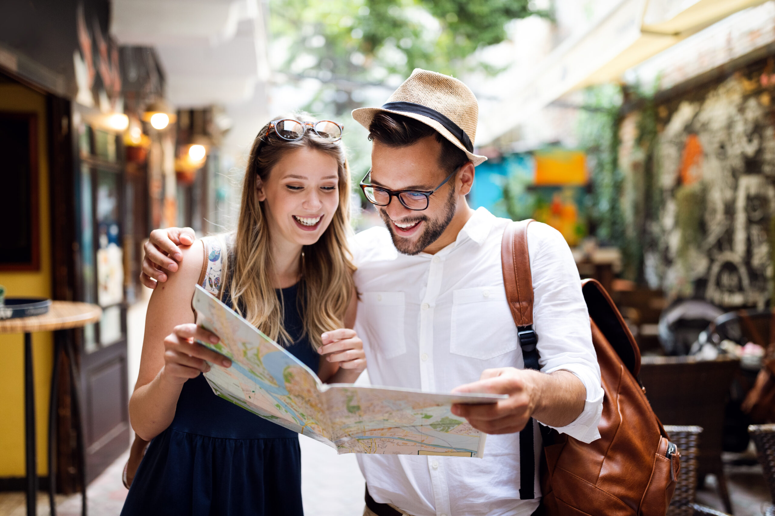 Travel. Tourist couple traveling, Walking on street. Portrait of beautiful young people